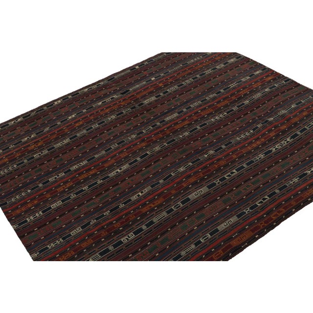 Handmade in wool, circa 1950-1960, this 5x6 vintage Shahsavan tribal Persian Kilim rug, features geometric stripes across...