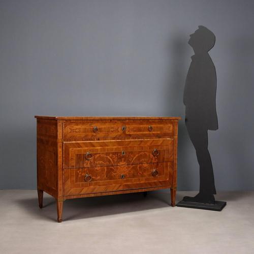 Neoclassical walnut chest of drawers, richly inlaid with boxwood, rosewood and olive wood frames, and maple trim. The top...