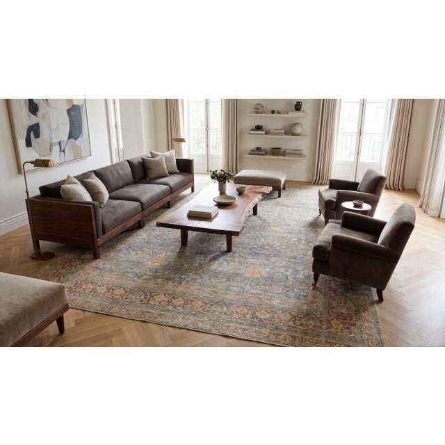 This exquisite turn-of-the-century antique Mashad rug showcases a sophisticated allover field of scrolling vines, delicate...