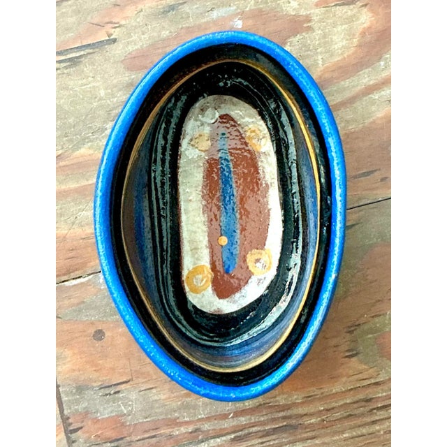This dynamic vintage studio pottery piece offers a vibrant fusion of rustic texture and bold color, perfect for an...