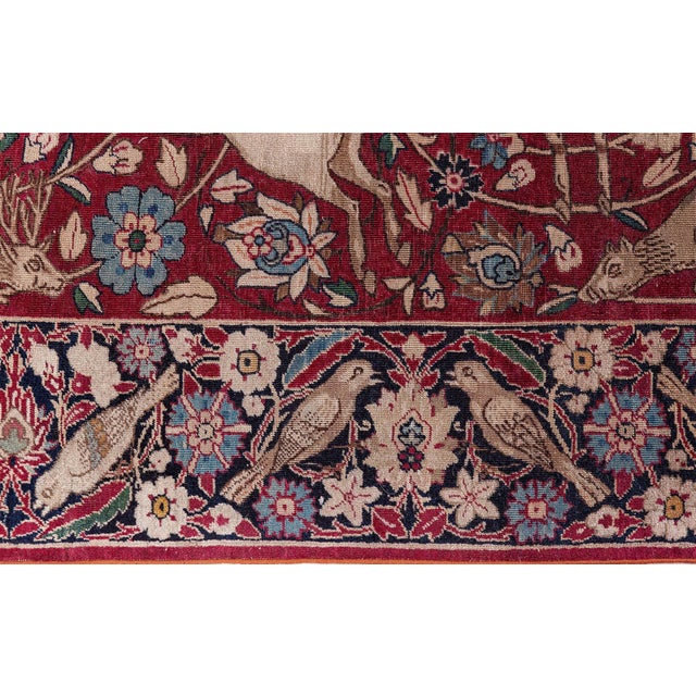 This exquisite antique Persian Kirman fragment runner from circa 1900 is a rare and richly expressive textile that...