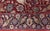 This exquisite antique Persian Kirman fragment runner from circa 1900 is a rare and richly expressive textile that...