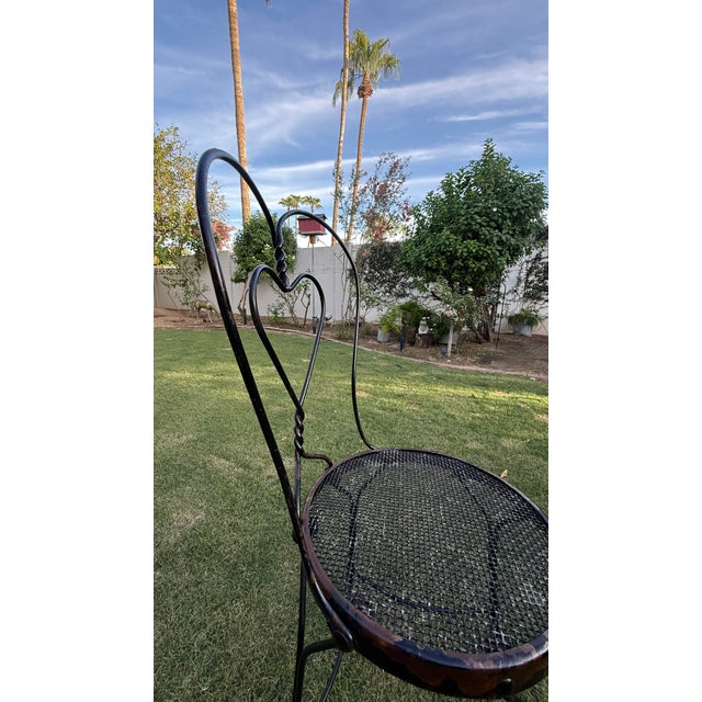 Elevate your space with this enchanting pair of authentic, vintage mid-century wrought iron bistro chairs. Featuring the...