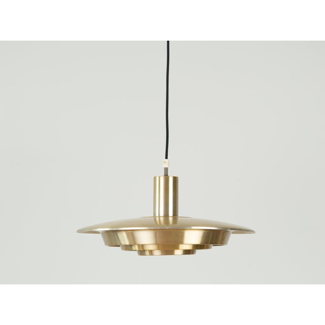 This lamp was designed by Danish designer Kurt Wiborg and manufactured by Jeka. The lamp's form is based on the principle...