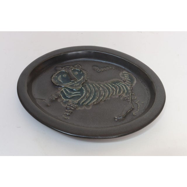 Matte brown-charcoal and green glazed ceramic tiger relief plate/plaque designed by David Gil for Cooperative Design...
