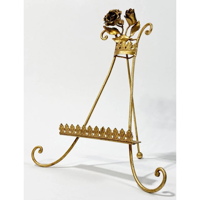 Vintage Italian gilt Tole table easel with ornate base board, curled feet, and intricate floral detail adorning top. Ball...