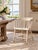 This antique Windsor captain’s chair dates to the early 20th century and features a continuous curved back and arms,...