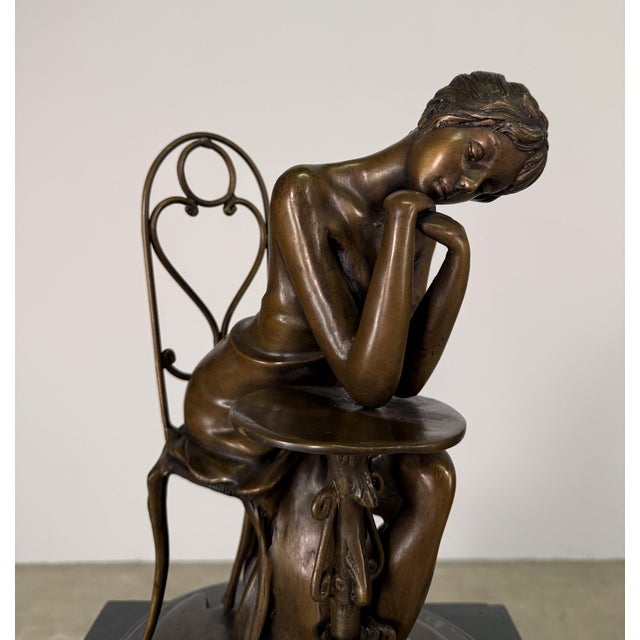 Art Nouveau-style bronze sculpture depicting a Parisienne lady in quiet contemplation at a café table. Graceful and...