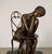 Art Nouveau-style bronze sculpture depicting a Parisienne lady in quiet contemplation at a café table. Graceful and...