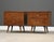 A pair of mid century modern solid maple two drawer nightstands with aluminum ring pulls and canted legs designed by Paul...