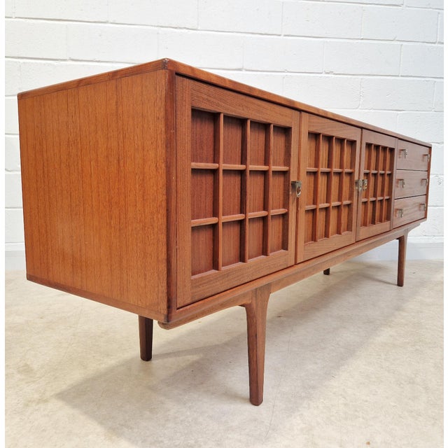 This stunning sideboard, a "long john" model from the esteemed british manufacturer a. Younger ltd., is a masterpiece of...