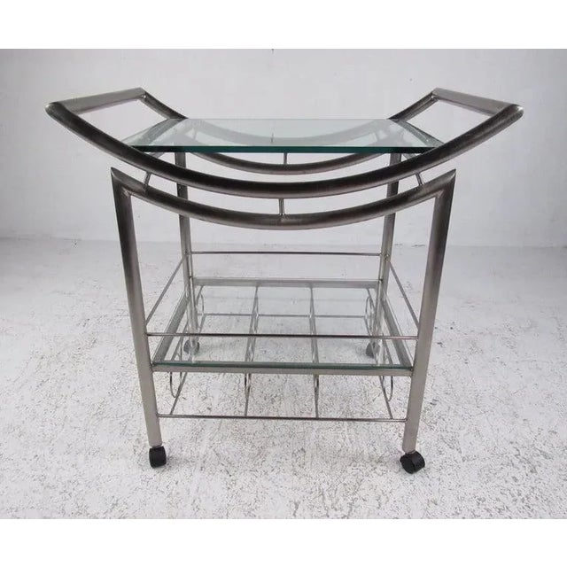 Modern bar cart on casters with 2 glass shelves for storagepreparation and 8 bottle wine storage rack. with dealer....