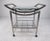 Modern bar cart on casters with 2 glass shelves for storagepreparation and 8 bottle wine storage rack. with dealer....