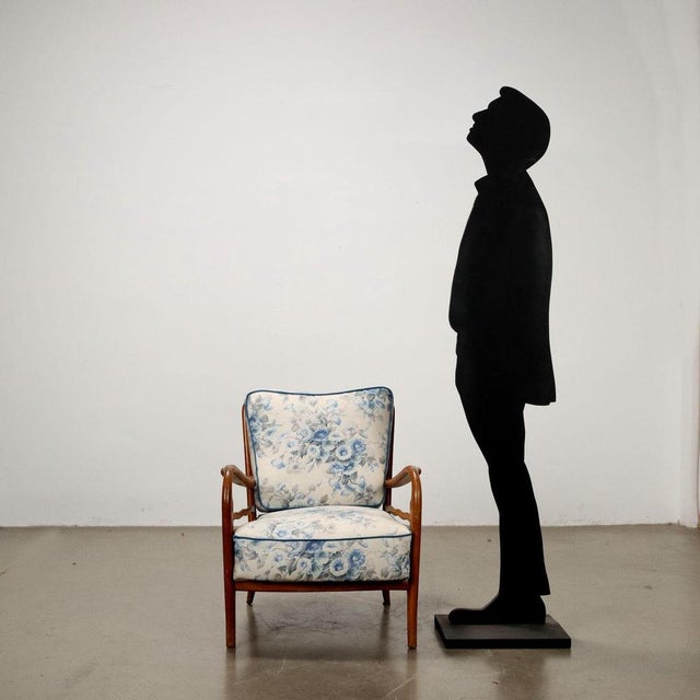 Armchair with exposed beech wood structure, spring padding, fabric covering. This piece is attributed to the mentioned...