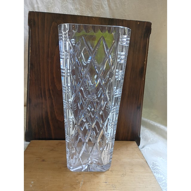 An exceptionally heavy and brilliant vintage clear cut crystal flower vase, presenting a timeless architectural...