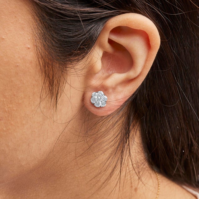 Indulge in the ethereal beauty of these exquisite floral cluster stud earrings, a masterpiece in 14K white gold. Each...