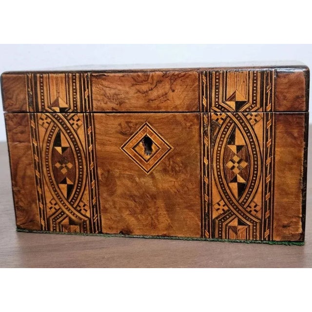 A well-made antique, circa 1830, English tea caddy with stunning marquetry inlays, warm coloring, superb detailing, and...