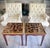 This striking pair of handcrafted Peruvian end tables features reverse-painted glass tops in a rich palette of amber,...