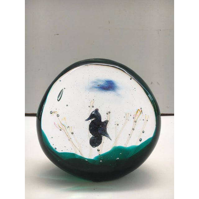 Beautiful seahorse in glass orb like sculptural piece. Mostly clear with added green. It is signed but very hard to...