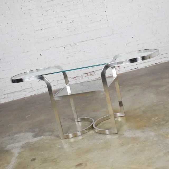 Fabulous mid-century modern polished chrome sofa or console table, lower shelf with glass insert, and oval glass top....