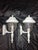 White outdoor wall lantern sconces featuring classic domed caps, clear seeded glass shades, and brass hardware. These each...