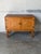 This functional storage cabinet features two paneled doors opening to reveal spacious interior shelving. Elevated on...