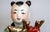 Red 1940s Hand Painted Porcelain Chinese Figuirines on Gourds Bearing Gifts - a Pair For Sale - Image 8 of 12