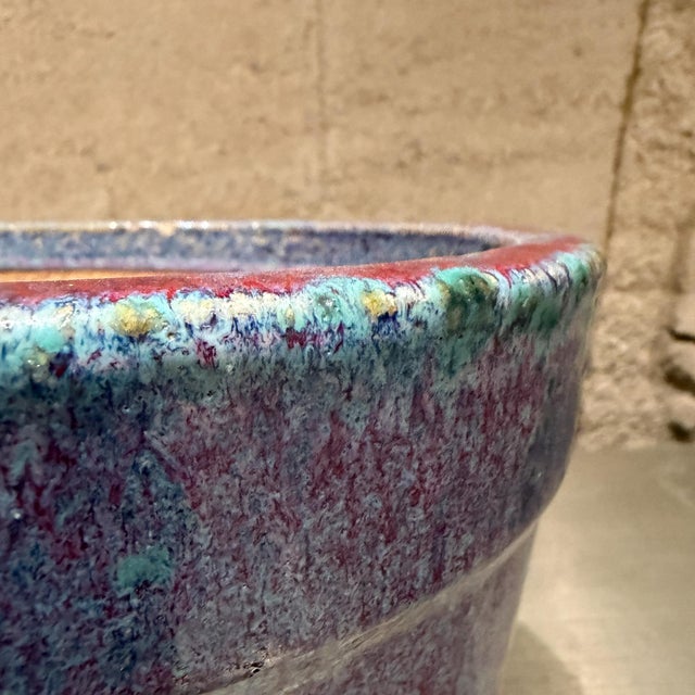 For your consideration, a vibrant ceramic flower pot featuring a striking drip-glaze finish. The design blends shades of...
