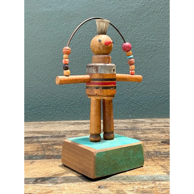 This vintage wood and metal found object sculpture brings whimsical folk-art charm to any collection, its playful humanoid...