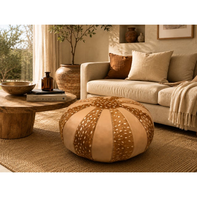 Bring warmth and authentic Moroccan character to your interior with this handcrafted leather pouf, made by skilled...