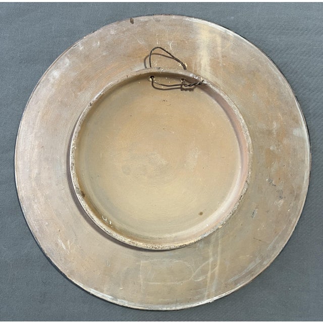 Hand-painted terracotta plate with female figure. first half of the 20th century. External diameter 43.5 cm. high 4.8 cm....