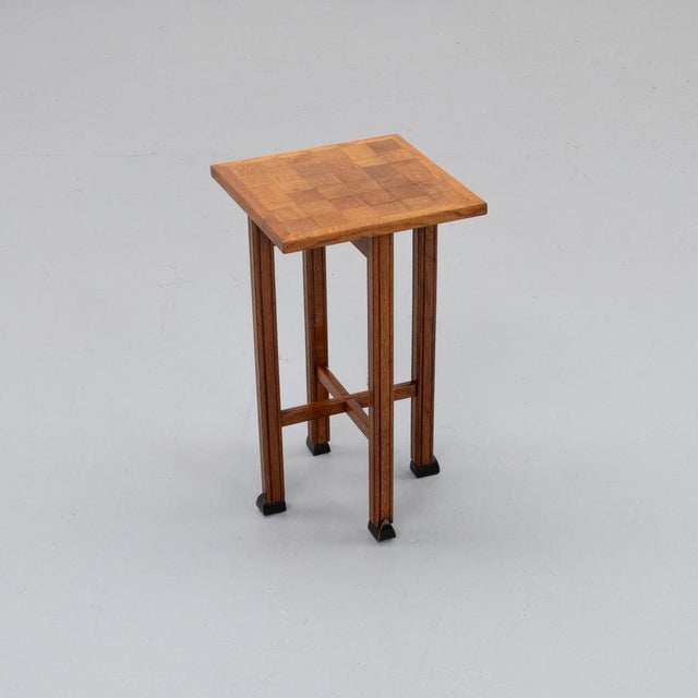 1920s side table in Art Deco / Amsterdam School style. Made of solid oak with an inlaid square block pattern top. The...