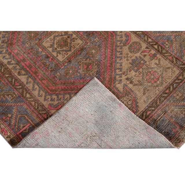 Beautiful vintage Malayer Persian hand-knotted wool runner with a tan field. This piece has pink, brown, and blue accents...