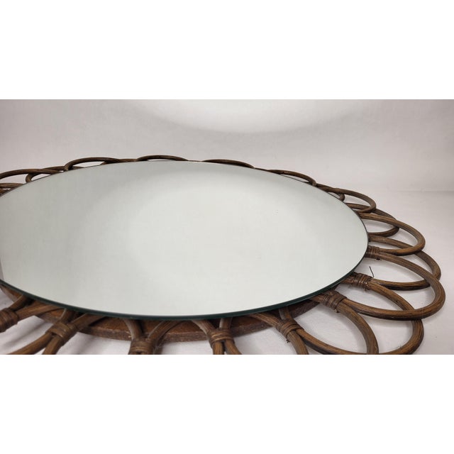 Large 1970s rattan sunburst mirror. Total width 68 cm. Total height 88 cm. It is in impeccable condition.