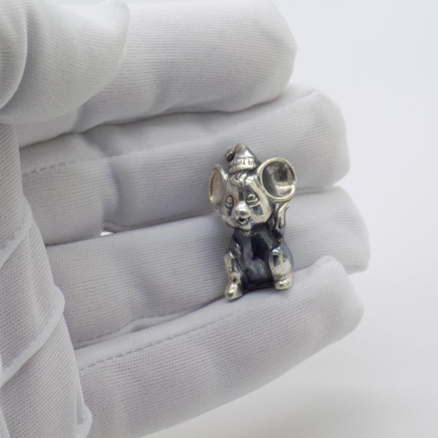 This vintage silver decorative object depicts a sweet cartoon mouse wearing a hat, crafted as a whimsical desktop accent,...