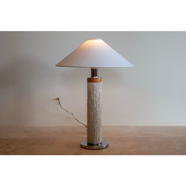 A simple, yet sculptural pair of vintage table lamps, likely produced in the 1980s, featuring a textured woven surface...