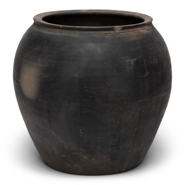Sculpted during the early 20th century in China's Shanxi province, this terra cotta vessel has a smoky taupe-black...