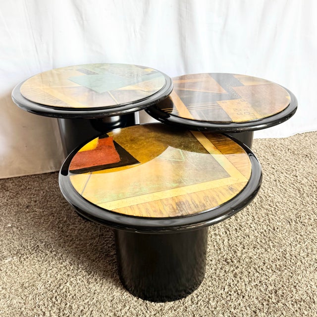 A striking trio of postmodern nesting tables, each crowned with a glossy abstract art surface that blends geometric form...