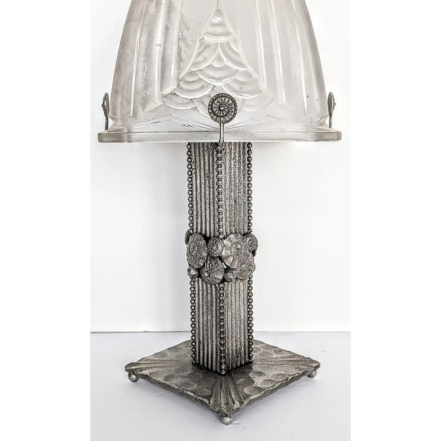 A rare French Art Deco hand-forged wrought iron table lamp embracing a glass shade Signed by the French artist Schneider...