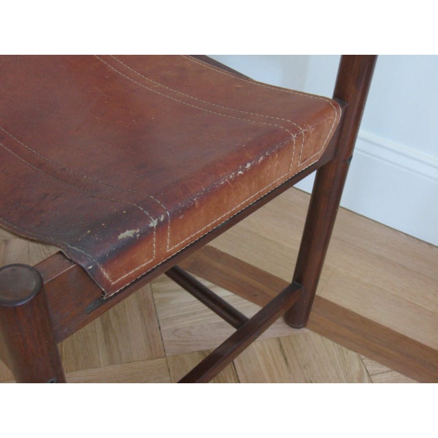 Mid-Century Imbuia chair designed by Brazilian designer Michel Arnoult. This sling chair has a rosewood frame with leather...