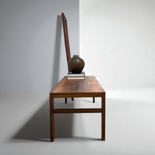 Minimalist proportions and sculptural details in richly toned palisander Elegant Danish entry bench attributed to Aksel...