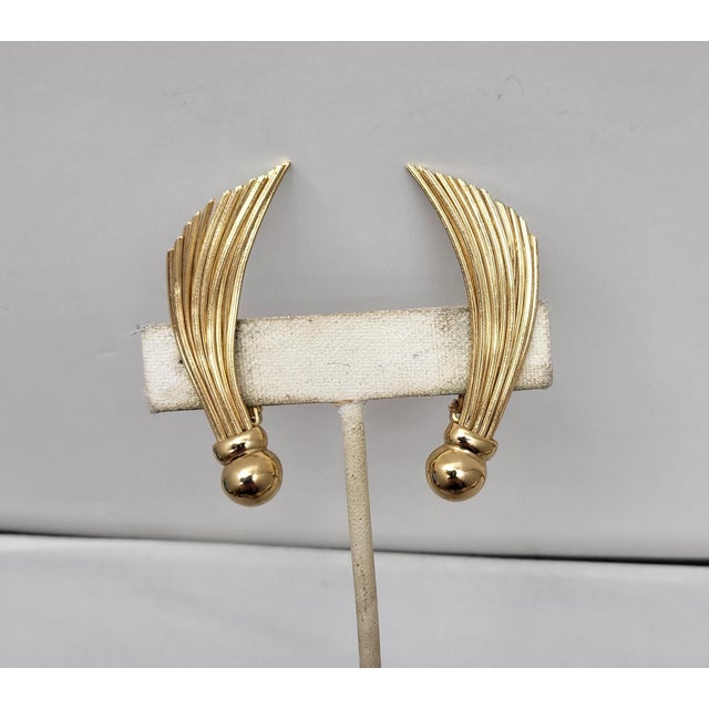 This is part of Chairish’s Costume Jewelry assortment. 1950s goldtone ball bottoms with brushlike wires protruding from...