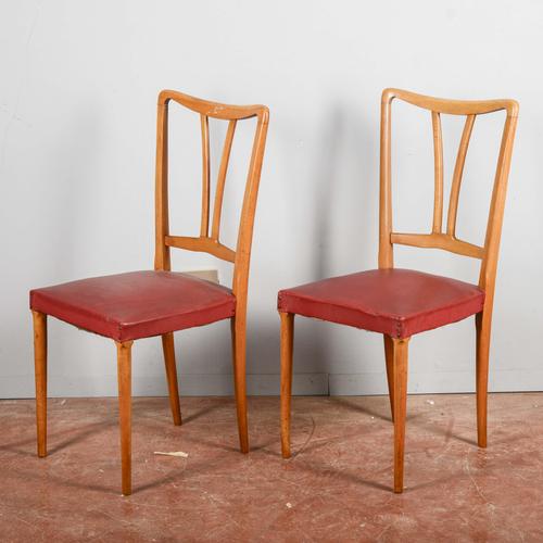This pair of chairs dating back to the mid-twentieth century is a vibrant example of modernism, distinguished by the...