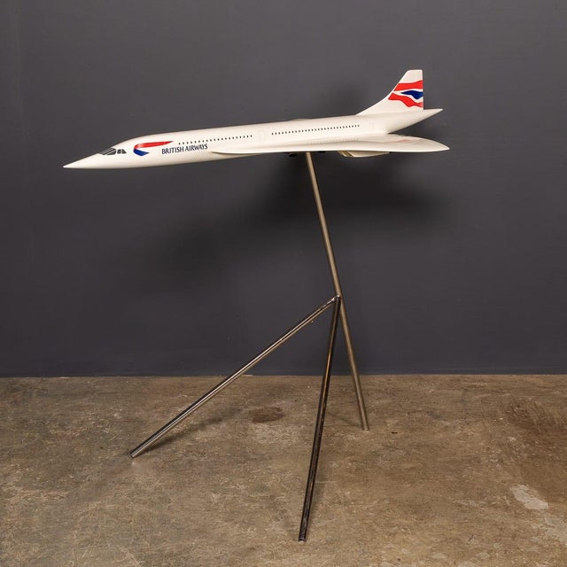 A vintage 20th century fibreglass and plastic composite model of a concorde in full british airways livery mounted on a...