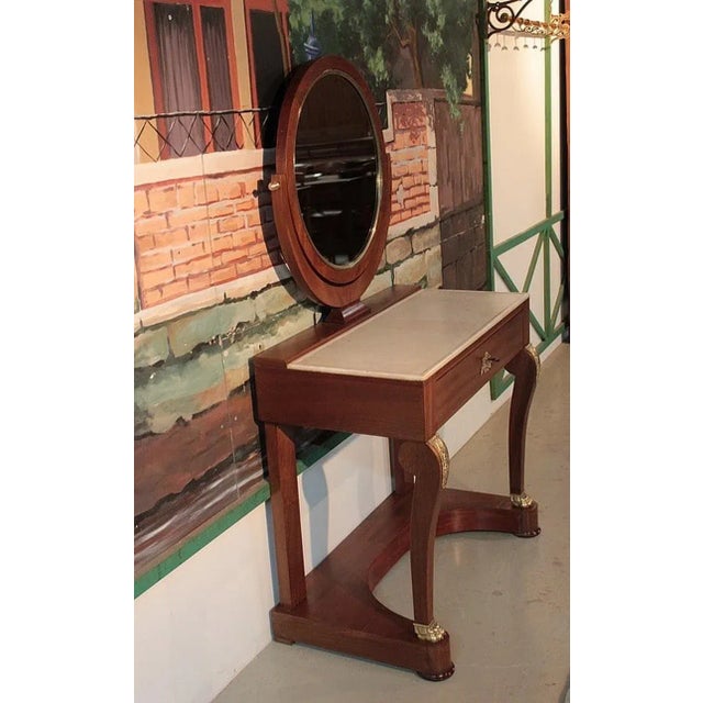 Mahogany catering hairdresser and mahogany veneer. It opens with a drawer with bronze entrance, its top is in white marble...