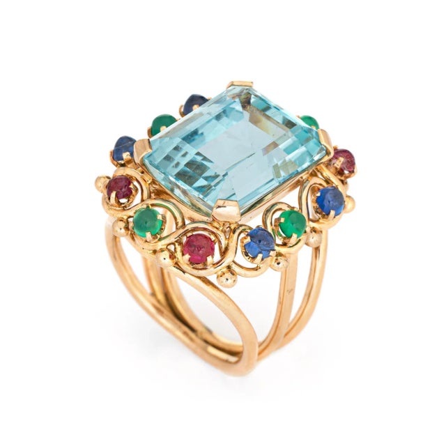Stylish vintage aquamarine & emerald cocktail ring (circa 1950s to 1960s) crafted in 14 karat yellow gold. Emerald cut...