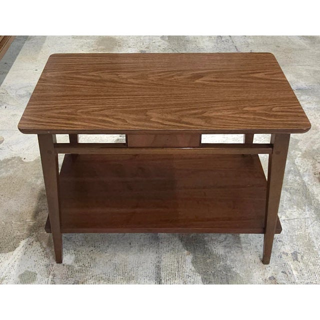A Lane Furniture Mid Century Style Tiered Walnut Side Table. Solid Walnut frame with laminated Walnut top Measure 29.75"...