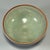 This vintage‑style celadon bowl features delicate natural crackled pale‑green glaze and an attractive brown‑toned rim....