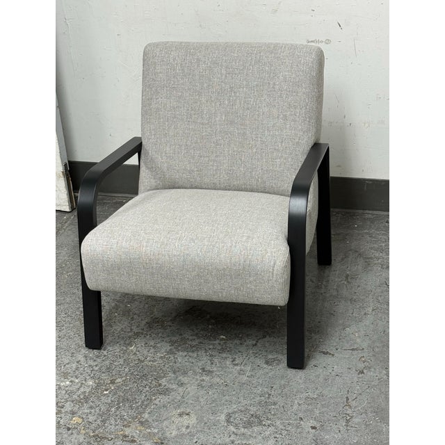 Design Plus Gallery presents a Bespoke Felix Chair. This lounge chair is upholstered in a light neutral textile. The black...