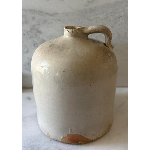 Vintage stoneware crock whiskey jug (approximately 5 gallon). Heavy stoneware construction with a handle and wonderful...